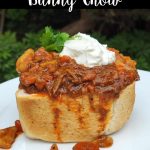 South African bunny chow, a hollowed-out ¼ loaf of bread filled with beef curry, topped with a dollop of yogurt and cilantro.