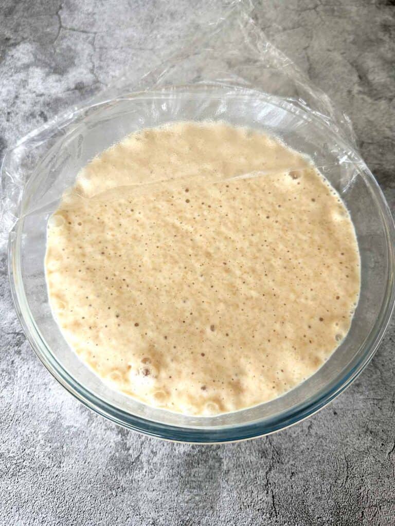 Bubbling batter in a glass bowl after 30 min rest