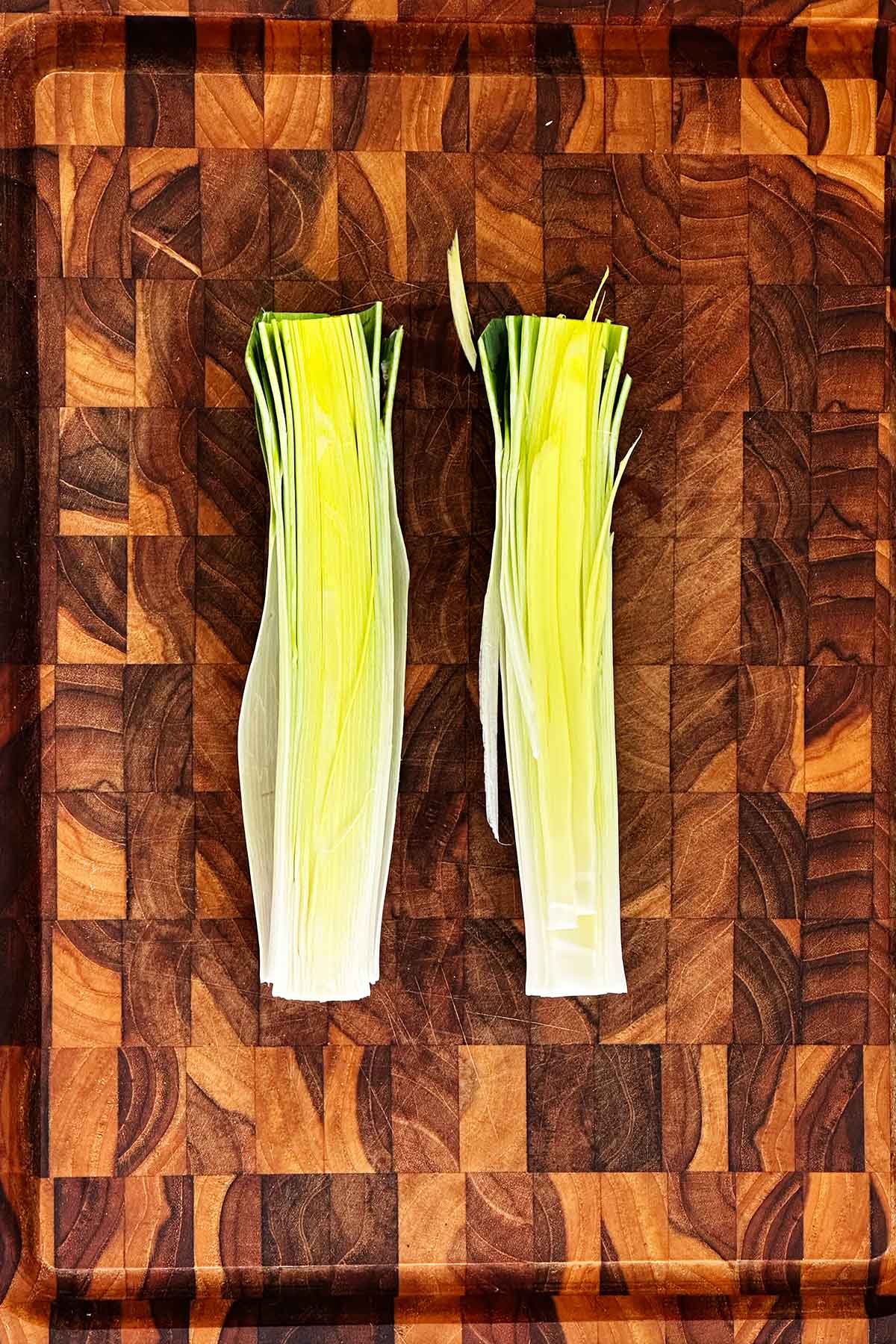 Slice leek lengthwise to open layers and prepare for cleaning