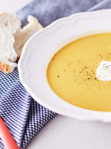 Bowl of pumpkin soup with toasted bread on the side