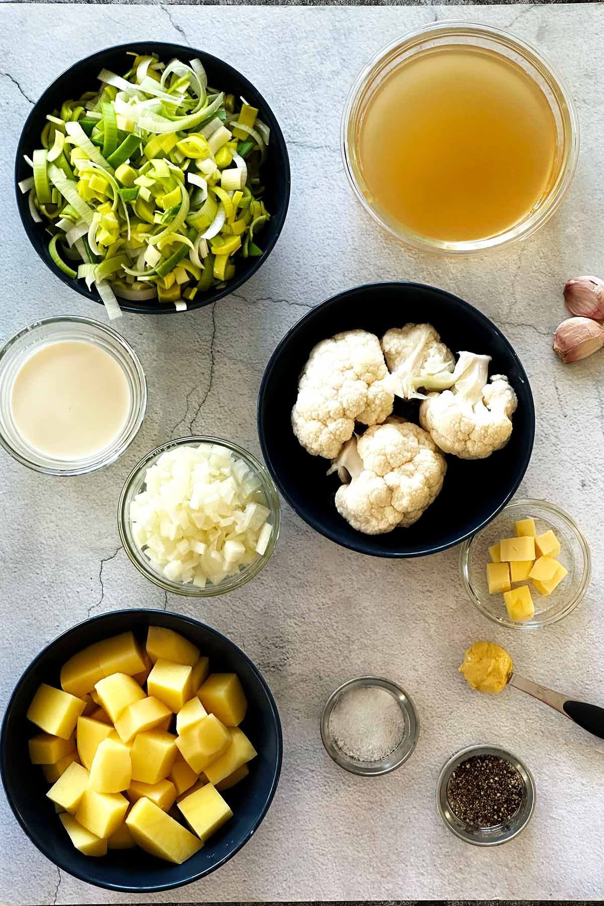 All the ingredients for the Leek potato cauliflower soup measured and placed on a kitchen bench