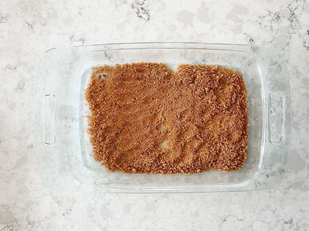 Brown sugar, paprika, and pepper mixture spread in tray for coating bacon for the bacon candy.