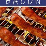 Candied streaky bacon on roasting rack on a foil lined baking sheet.