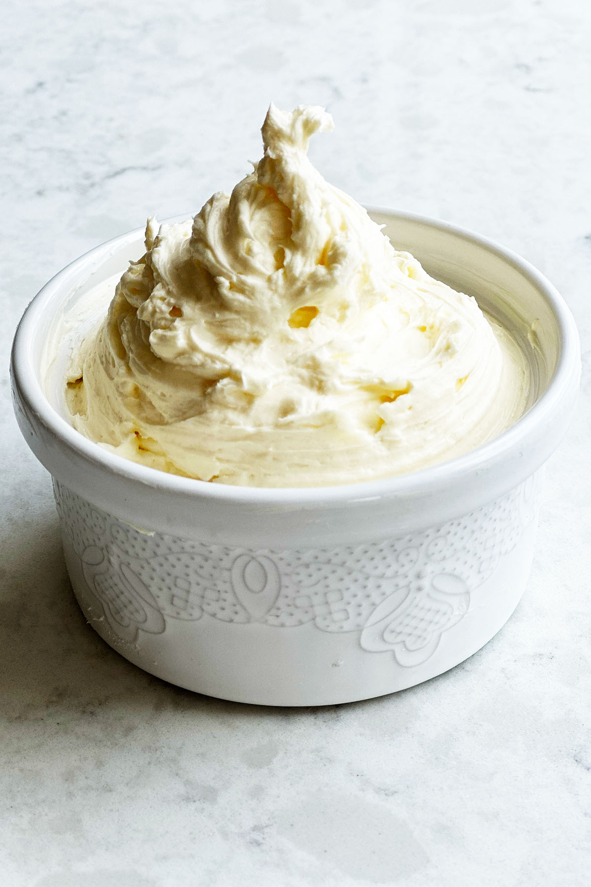 Whipped cream cheese in a small white bowl