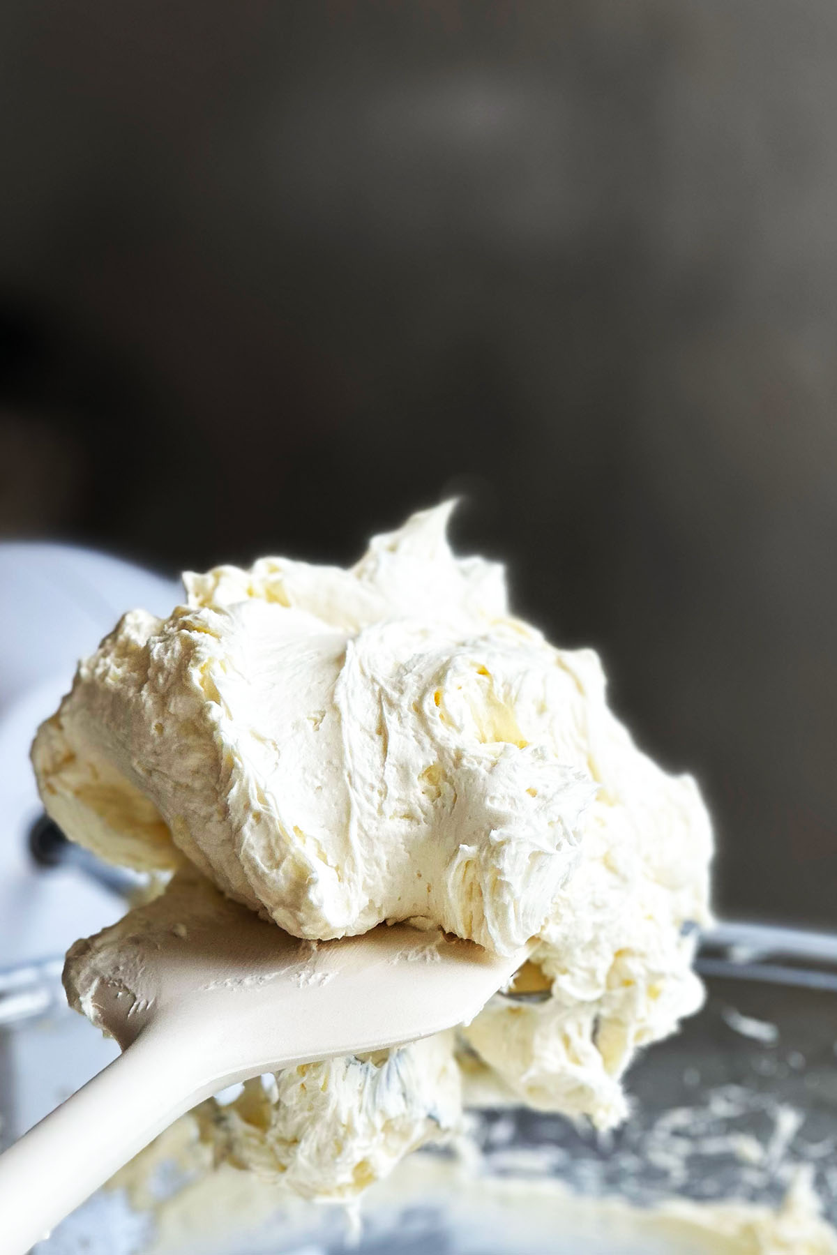 Fluffy whipped cream cheese on a spatula.