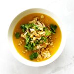 Creamy Moroccan pumpkin soup topped with shredded chicken, fresh coriander, and crushed chickpeas in a white bowl.A warm and creamy Moroccan pumpkin soup made from butternut squash and topped with tender shredded chicken and crushed chickpeas. This easy Moroccan chicken soup recipe is lightly spiced with Moroccan spices and brightened with preserved lemon for authentic flavour. Perfect Moroccan butternut squash soup for quick weeknight dinners.