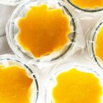 Large batch pumpkin soup poured into freezer bags held upright in glass jars