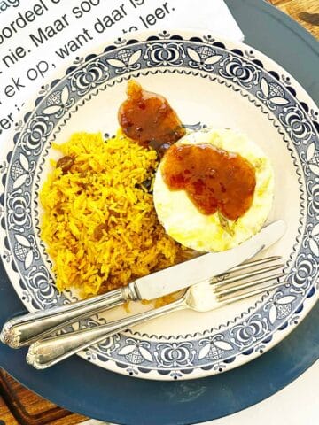 Bobotie with yellow rice, chutney drizzle, Afrikaans napkin and cutlery