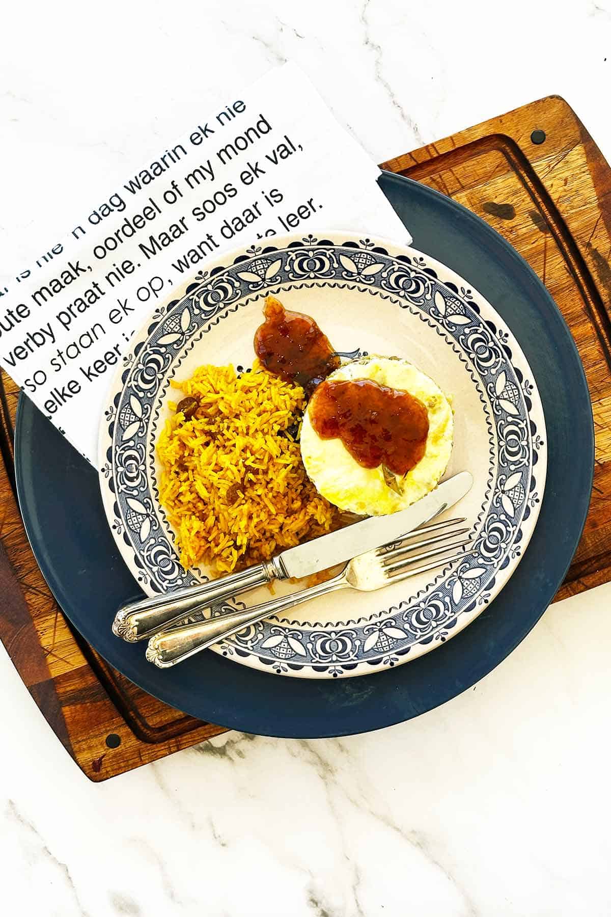 Bobotie with yellow rice, chutney drizzle, Afrikaans napkin and cutlery