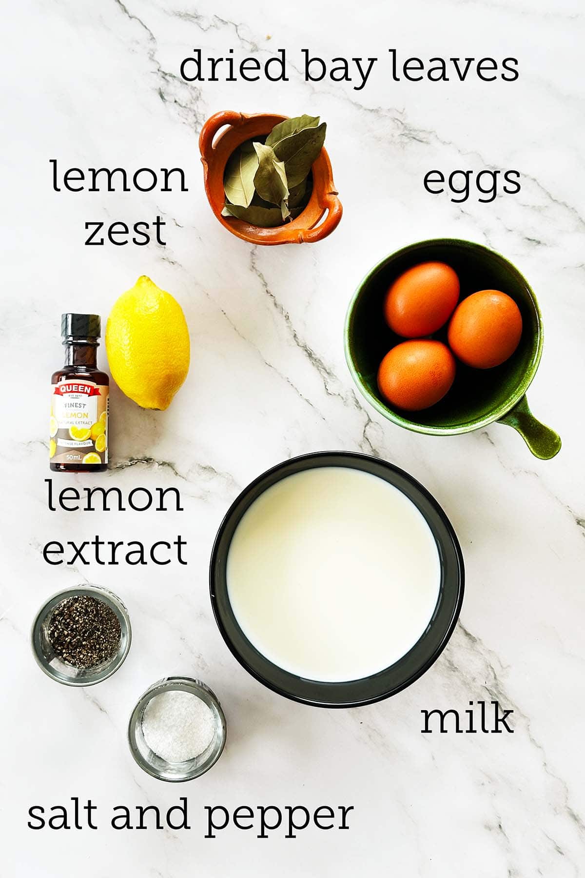 Bobotie custard topping ingredients with eggs, milk, lemon zest, bay leaves, salt and pepper