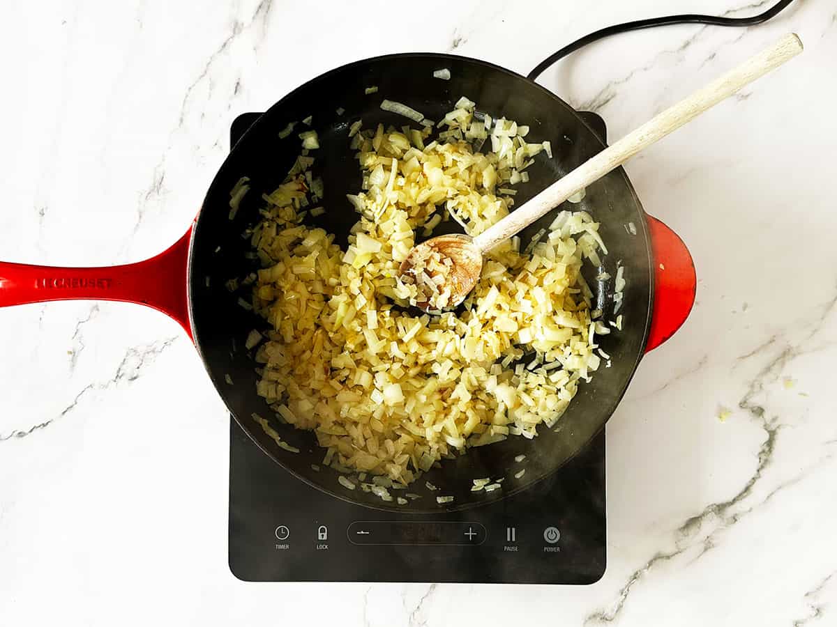 Onions cooking in skillet until soft, translucent and lightly golden
