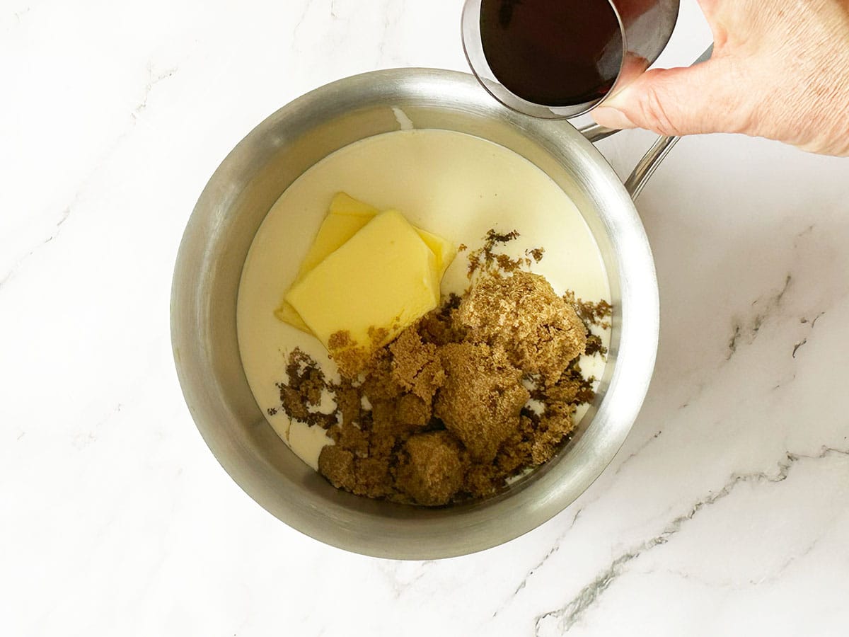Adding sherry to cream, butter and sugar in saucepan for Malva pudding sauce