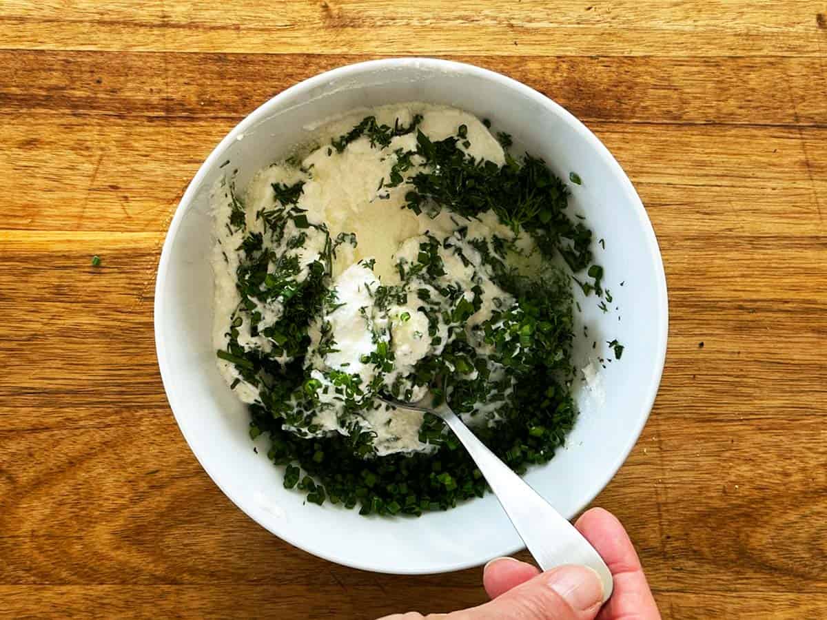 Stirring Greek yoghurt ranch dip until smooth and creamy.