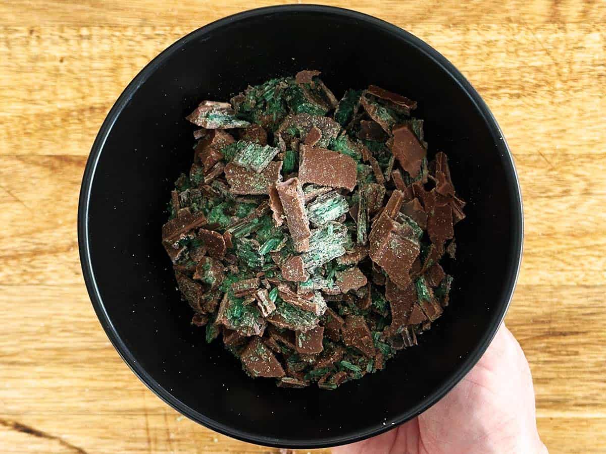 Crushed Peppermint Crisp chocolate pieces in a bowl for peppermint crisp tart