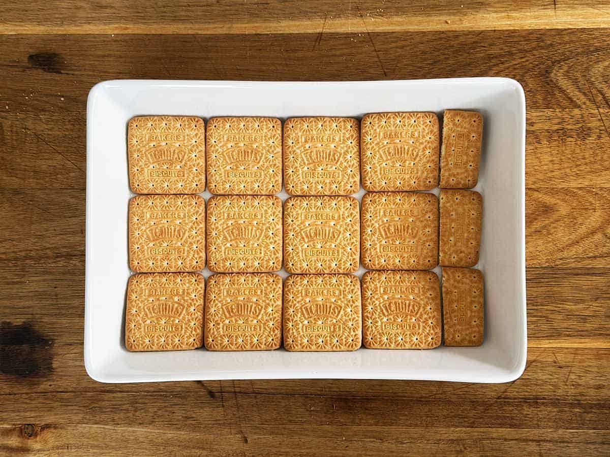 First layer of Tennis biscuits in a white dish for peppermint crisp tart