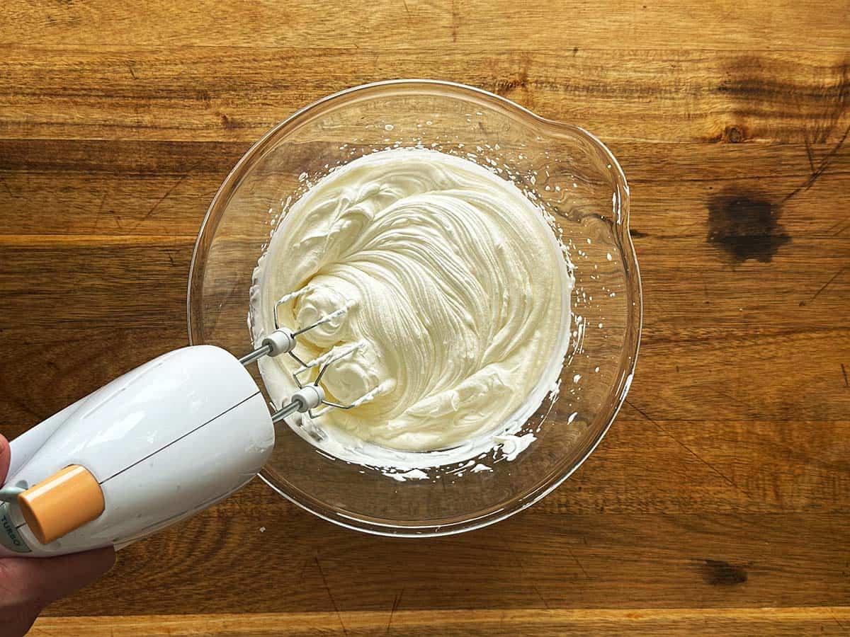 Whipping cream in a large bowl for peppermint crisp tart