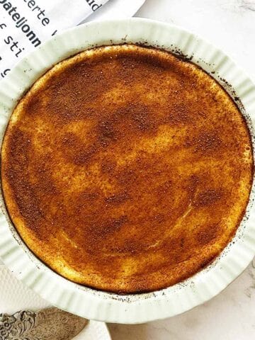 Golden crustless milk tart with cinnamon sugar topping in baking dish