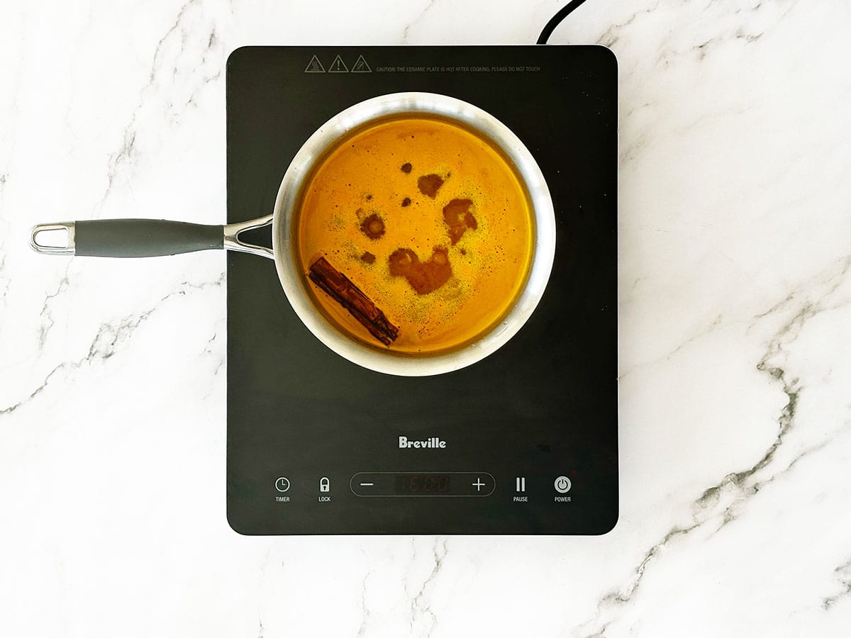 Pot of yellow rice water boiling on stove