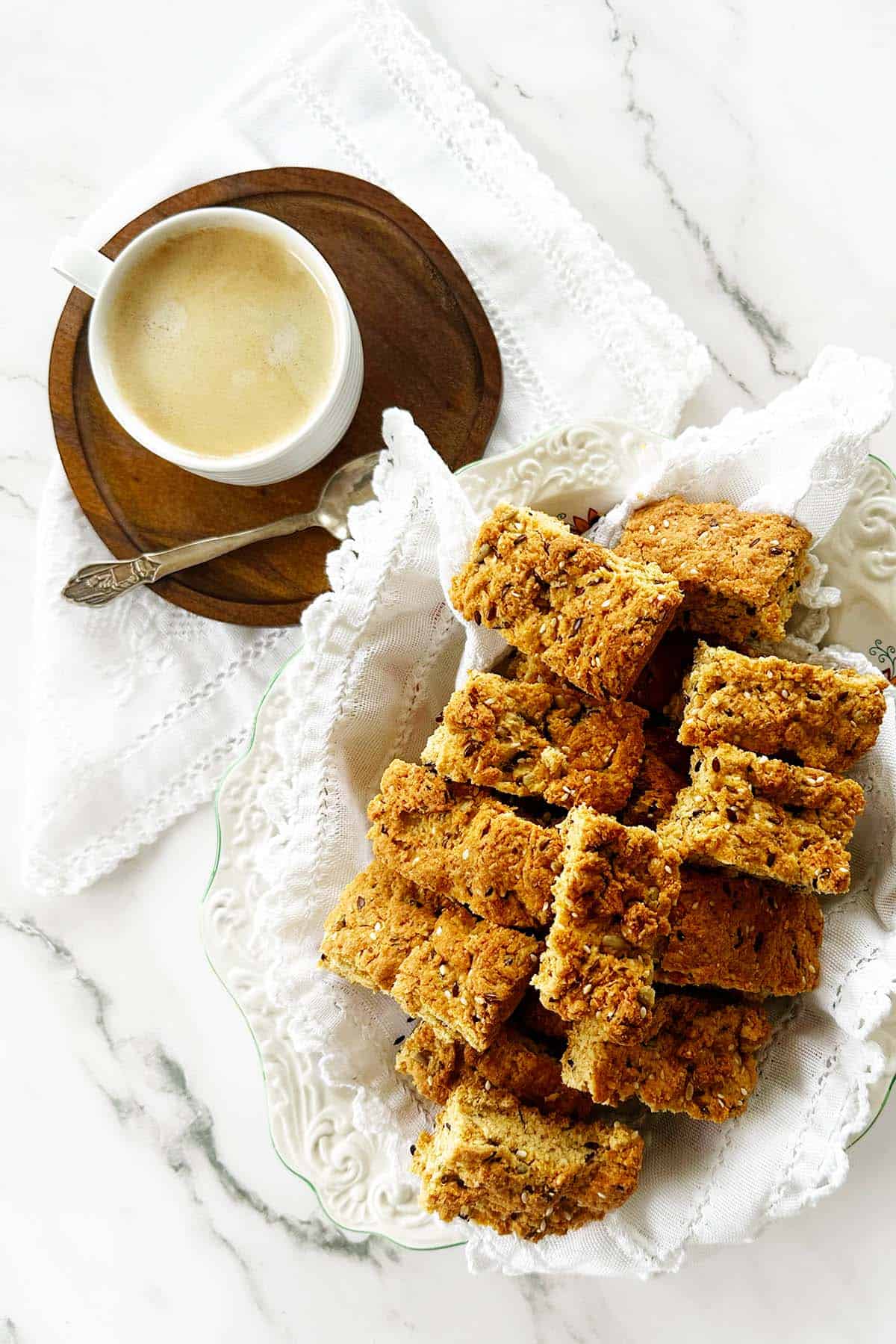 Healthy wholemeal seed rusks with coffee on serving platter