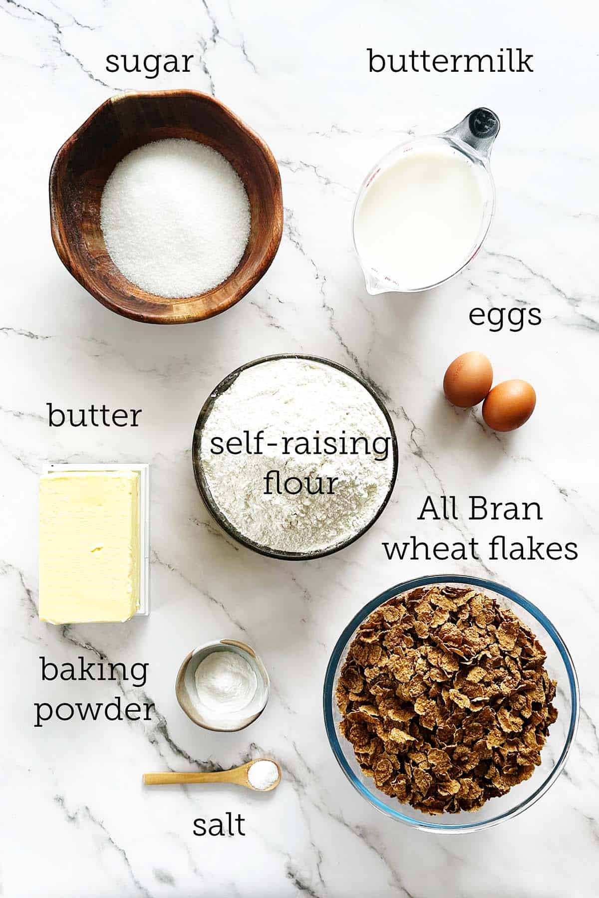 Ingredients for an all bran rusks recipe laid out on a marble surface