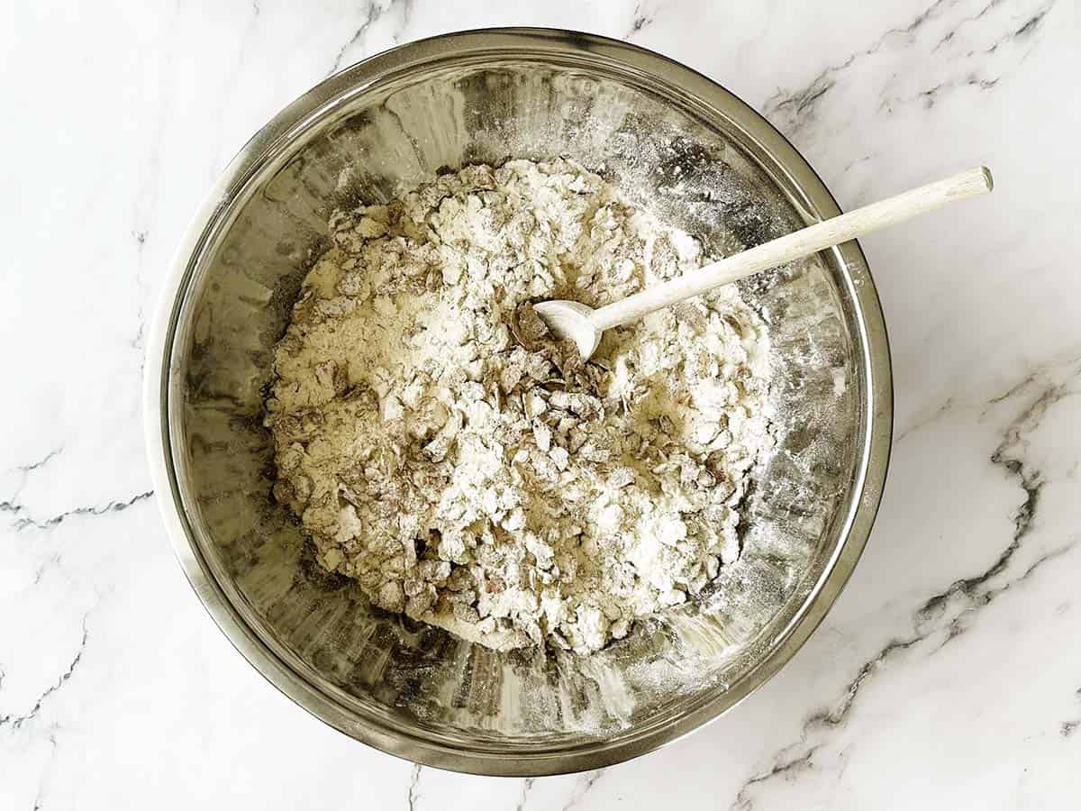 Self-raising flour and All Bran flakes being mixed in a large bowl