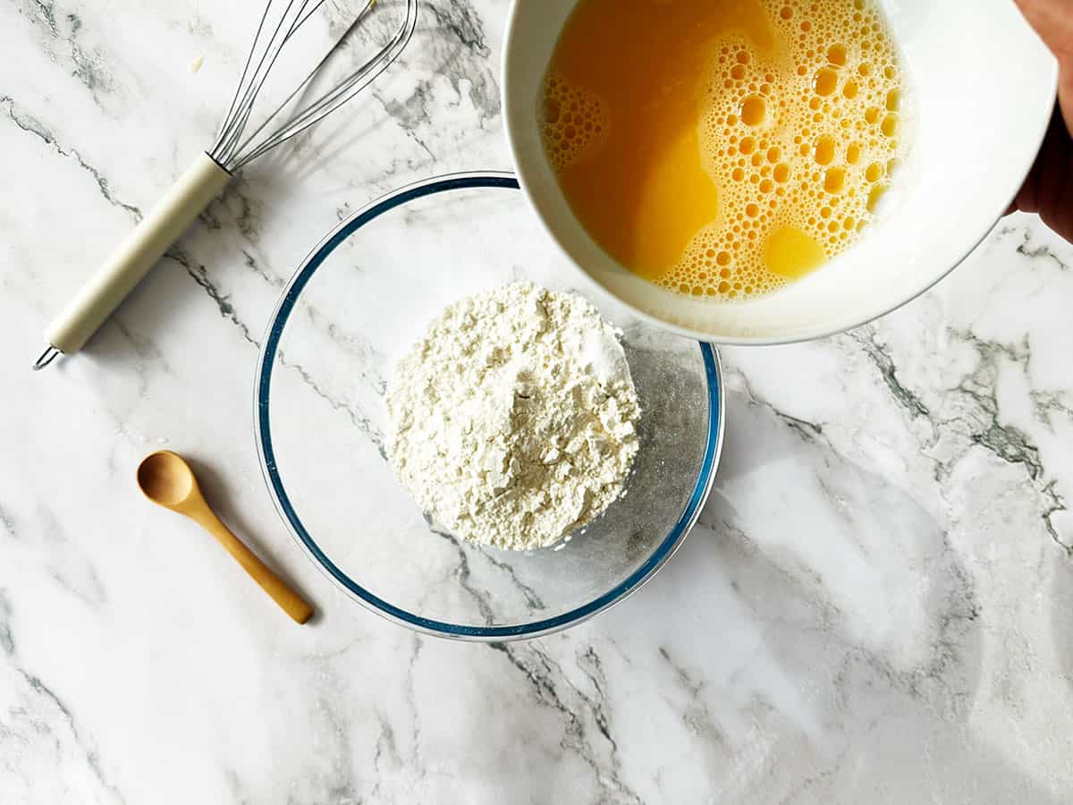 Mixing the egg mixture into the self-raising flour vetkoek mixture
