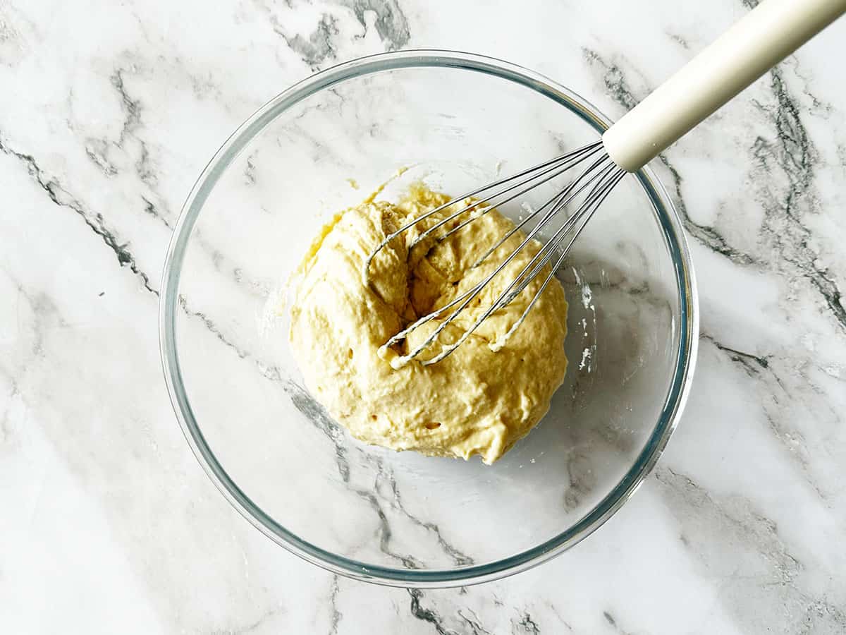 3 ingredient vetkoek dough using self-raising flour, egg and water mixed until thick vetkoek dough in a bowl