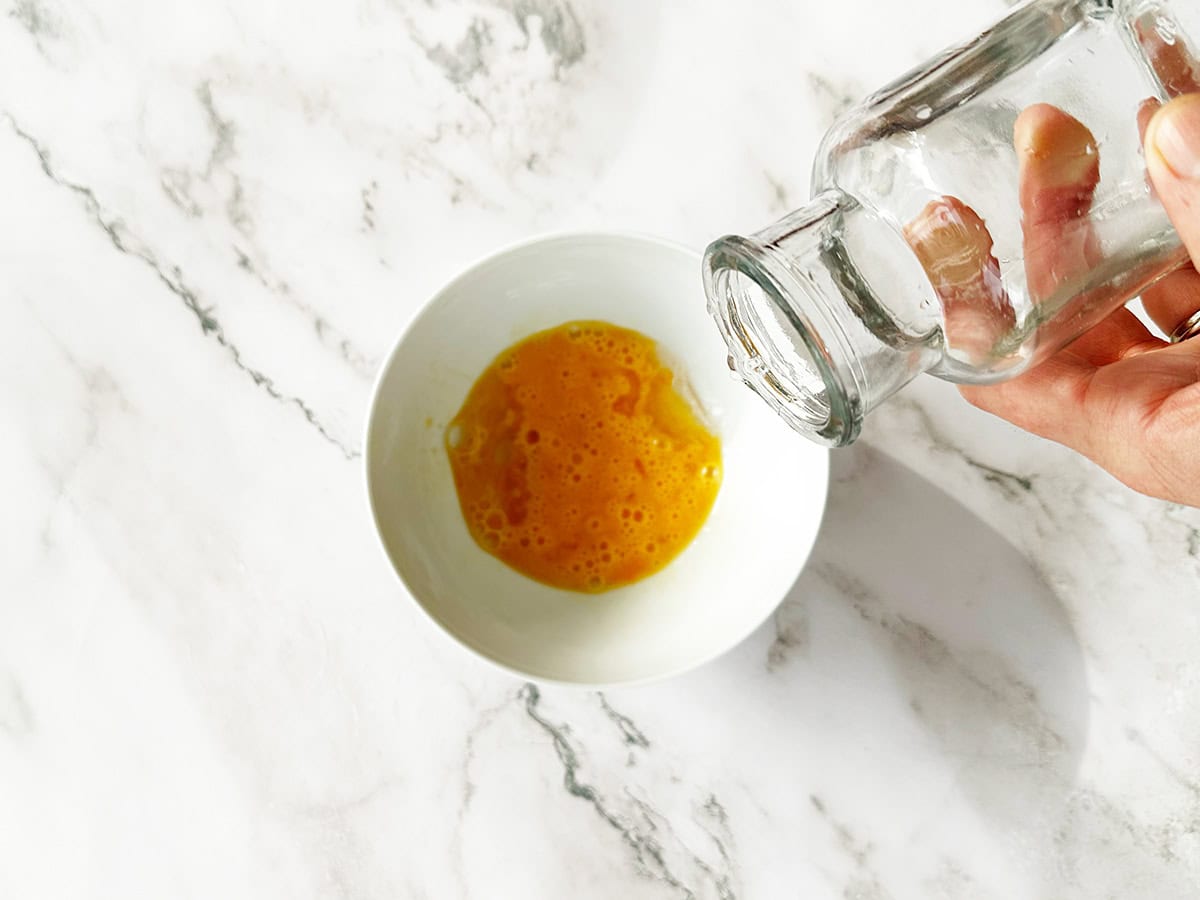 Adding the water to the whisked egg